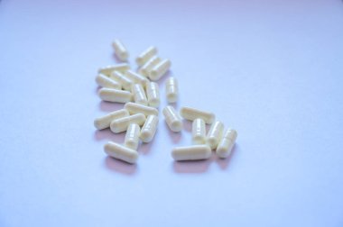 Medical White Capsules on White Background, Thailand.