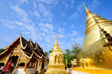 Ancient golden pagoda and Lanna style church at Wat Phra Singh temple, Chiang Mai province.