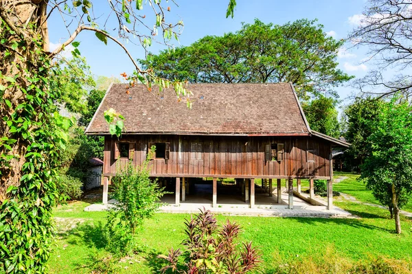 Lanna Traditional Building with Grass Yard in Chiang Mai Province, Thailand.