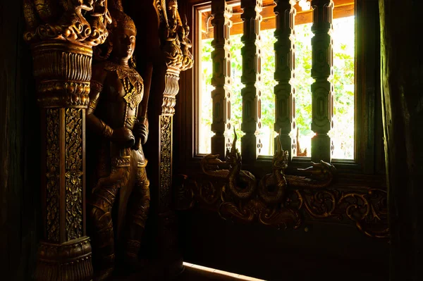 The Wooden Window with Wooden Statue of Thai Style Temple in Chiangmai Province, Thailand.