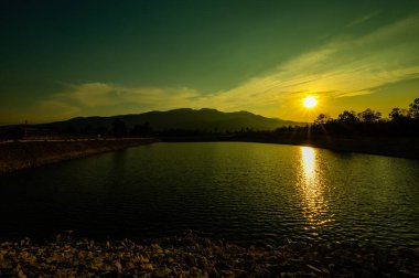 Reservoir with mountain view at sunset, Chiang Mai province.