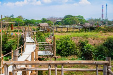 The bamboo bridge with rice field at Phrathat San Don temple, Lampang province.