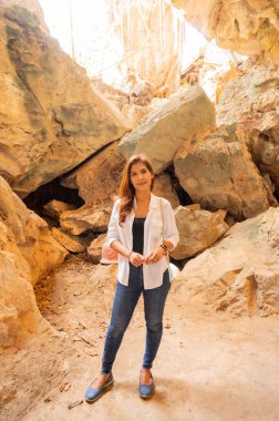 Asian woman with Tham Phra Sabai background, Lampang province.