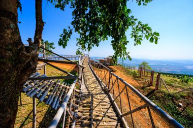 Wooden bridge with scenic view at Doi Sa Ngo viewpoint, Chiang Rai province.