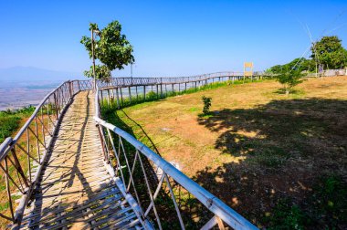 Wooden bridge with scenic view at Doi Sa Ngo viewpoint, Chiang Rai province.