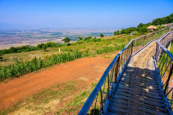 Wooden bridge with scenic view at Doi Sa Ngo viewpoint, Chiang Rai province.