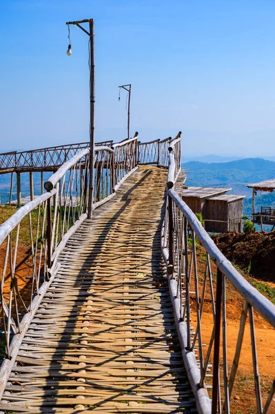Wooden bridge with scenic view at Doi Sa Ngo viewpoint, Chiang Rai province.