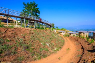 Wooden bridge with scenic view at Doi Sa Ngo viewpoint, Chiang Rai province.