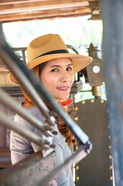 Asian woman with old carriage in Lampang province, Thailand.