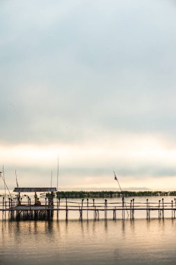 Small wooden bridge with Kwan Phayao lake at sunrise, Thailand.