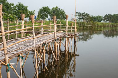 Small wooden bridge with Kwan Phayao lake at early morning, Thailand.