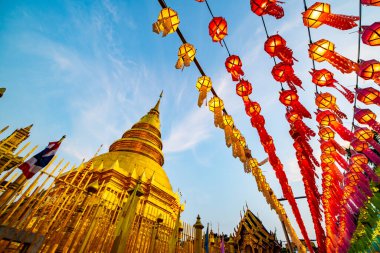 Lanna style lantern with ancient pagoda in Phra That Hariphunchai temple, Lamphun province.