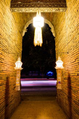 Night scene of Lanna style arch at Lok Molee temple, Chiang Mai province.