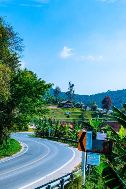 Road with native village on mountain in Doi Inthanon national park, Thailand.