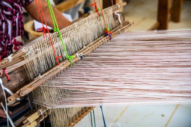 Native thread on Thai traditional weaving machine, Thailand.