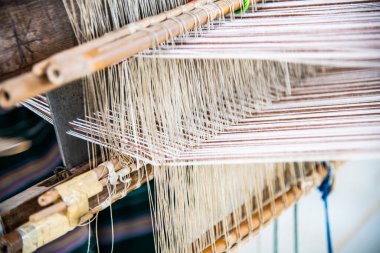 Native thread on Thai traditional weaving machine, Thailand.