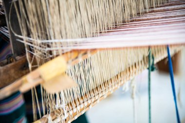 Native thread on Thai traditional weaving machine, Thailand.