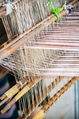 Native thread on Thai traditional weaving machine, Thailand.