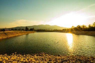 Reservoir with mountain view at sunset, Chiang Mai province.