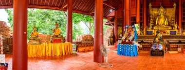 CHIANG RAI, THAILAND - July 18, 2020 :  Panorama View of Ancient Buddha Statue with Lanna Style Building in Wat Chedi Luang, Chiang Rai Province.