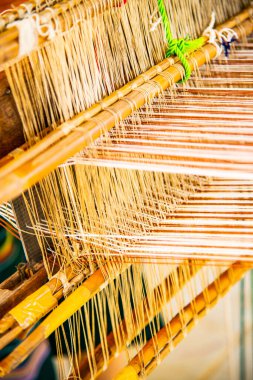 Native thread on Thai traditional weaving machine, Thailand.
