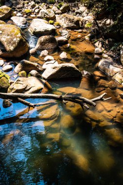 Rock with water flowing slowly in Sapan waterfall, Thailand.