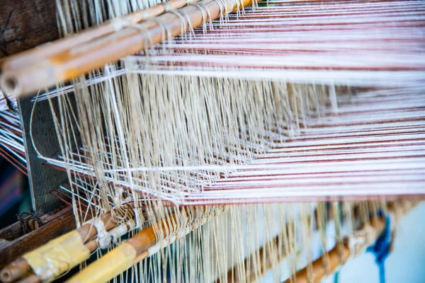 Native thread on Thai traditional weaving machine, Thailand.