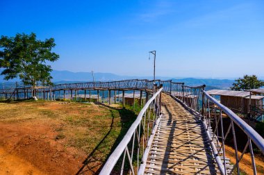 Wooden bridge with scenic view at Doi Sa Ngo viewpoint, Chiang Rai province.