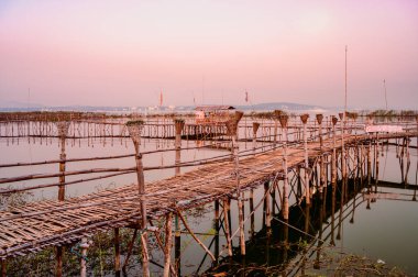Small Wooden Bridge with Soft Water in Kwan Phayao Lake, Thailand.