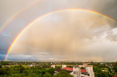 Double rainbow with local village, Chiang Mai province.