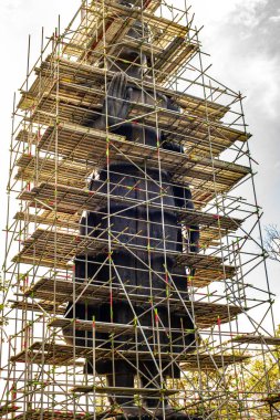 Big Standing Buddha under renovation in  Analyo Thipayaram temple, Thailand.