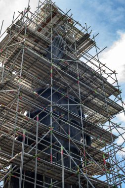 Big Standing Buddha under renovation in  Analyo Thipayaram temple, Thailand.