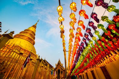 Lanna style lantern with ancient pagoda in Phra That Hariphunchai temple, Lamphun province.
