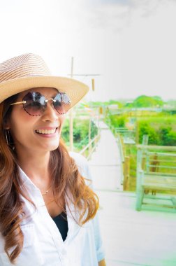 Asian woman with wooden bridge background, Lampang province.