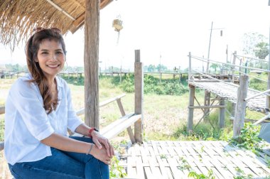 Asian woman with countryside background at Phrathat San Don temple, Lampang province.