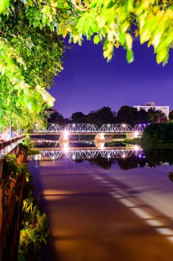 Iron Bridge with Ping River at Night in Chiang Mai Province, Thailand.