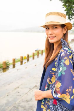 A Woman Traveler with Mekong River Background at Golden Triangle, Chiang Rai Province.