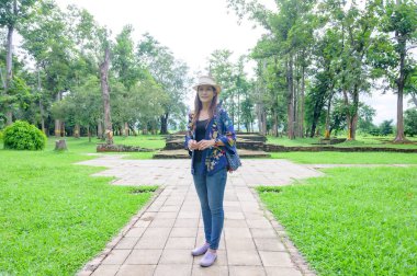 A Woman Traveler with Wat Pa Sak Background at Chiang Saen District, Chiang Rai Province.