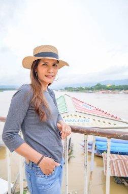 A Woman Traveler with Mekong River View at Golden Triangle, Chiang Rai Province.