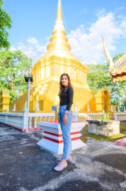 Thai Woman Tourist with Phrathat Phu Khwang Background, Phayao Province.