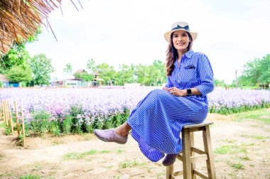 Thai Woman with Flower Garden Background at Chiang Mai Province, Thailand.