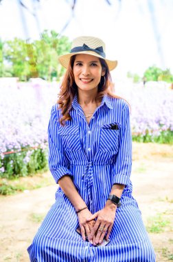 Thai Woman with Flower Garden Background at Chiang Mai Province, Thailand.