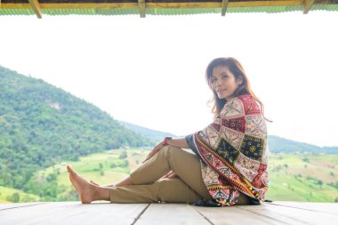 Asian Woman in Thai Native Pavilion with Rice Field Background at Pa Bong Piang Rice Terraces, Chiangmai Province.