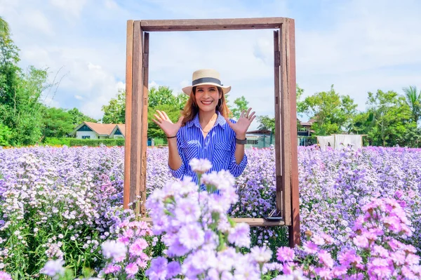 Thai Woman in Frame with Beautiful Flower Garden at Chiang Mai Province, Thailand.