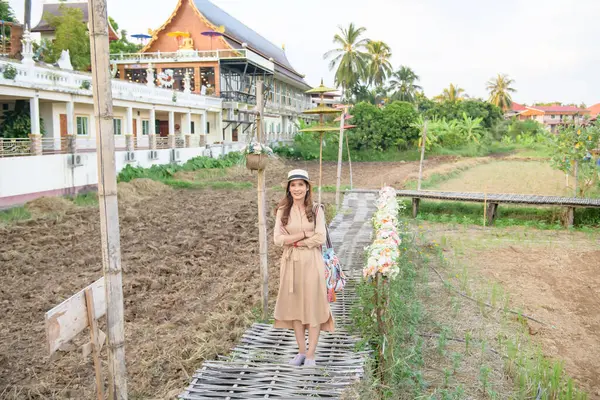 stock image Asian Woman with Rice Field Background at Si Mongkol Temple, Nan Province.