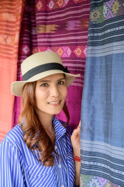 Thai Girl in Blue Dress with Thai Cloth Background, Nan Province.