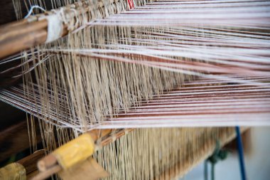 Native thread on Thai traditional weaving machine, Thailand.