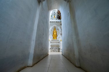 Temple entrance and golden Buddha statue at San Pa Yang Luang temple, Lamphun province.