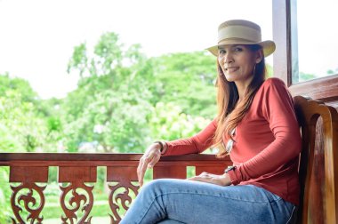 Asian woman at Thai style balcony, Phayao province.