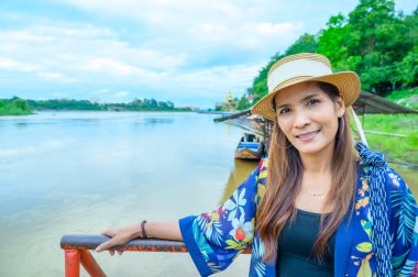 A Woman Traveler with Mekong River Background at Golden Triangle, Chiang Rai Province.